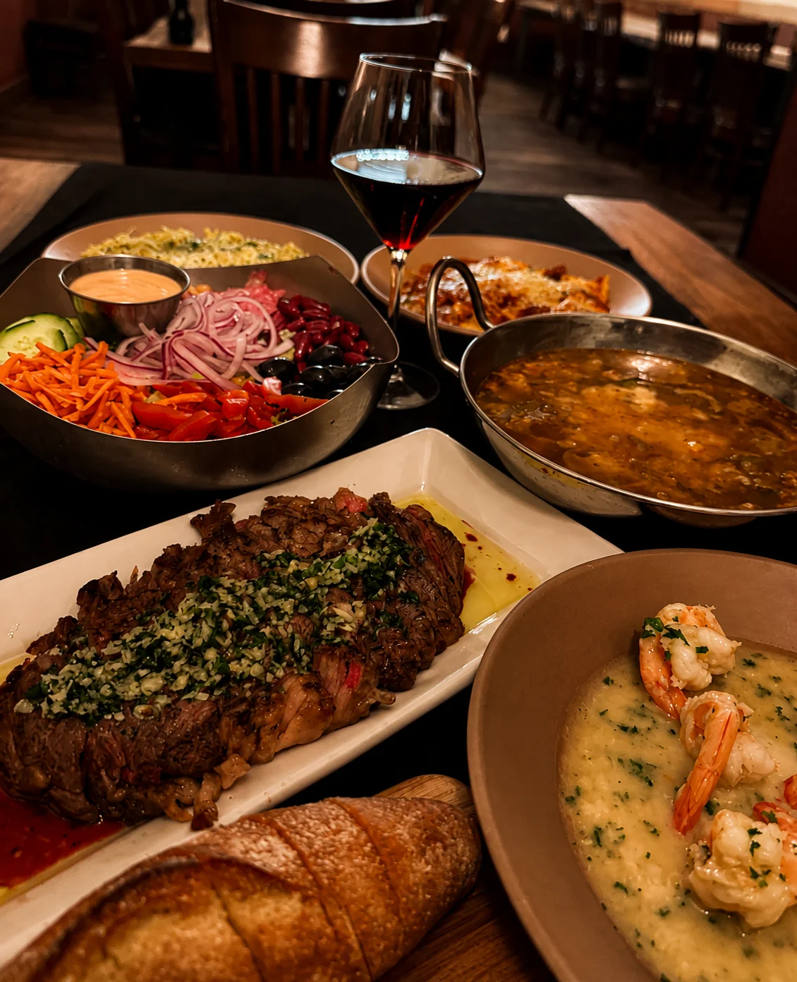 Grilled steak with sides in a cozy restaurant setting