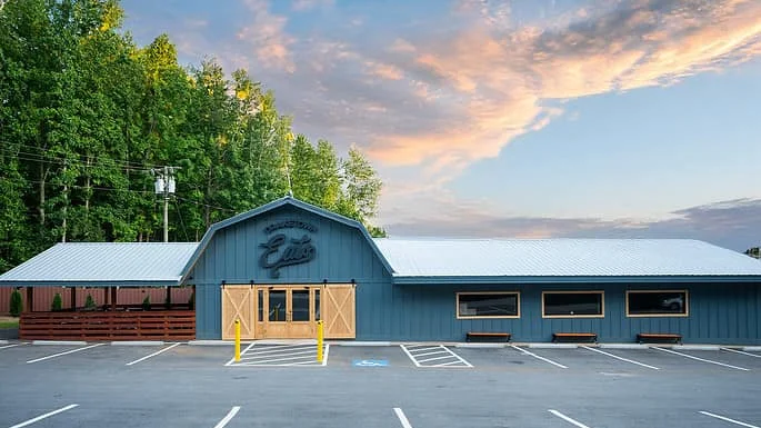 Charming restaurant exterior with rustic design and scenic backdrop