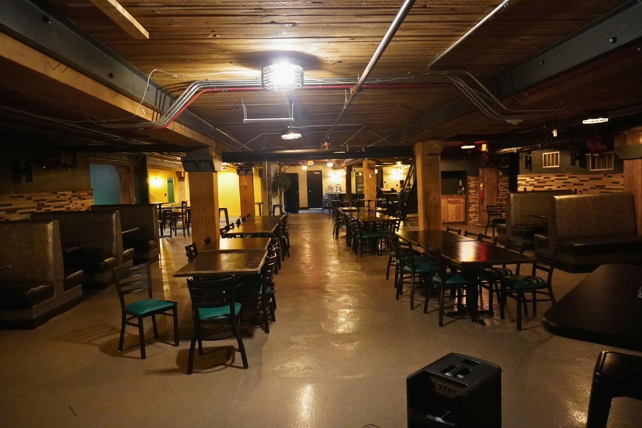 Spacious restaurant interior with wooden beams and cozy seating