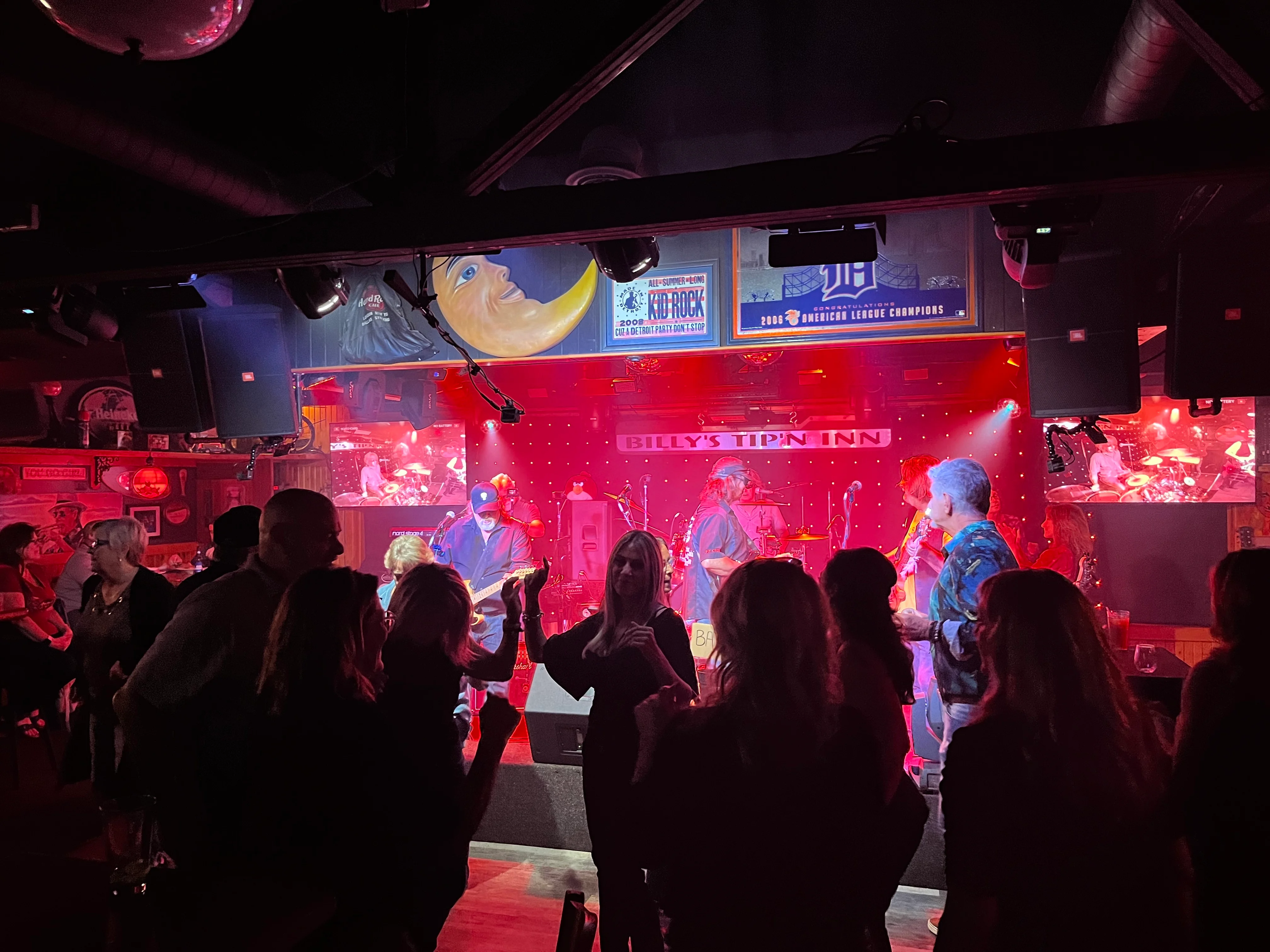 Live band performing at a vibrant bar with a lively crowd