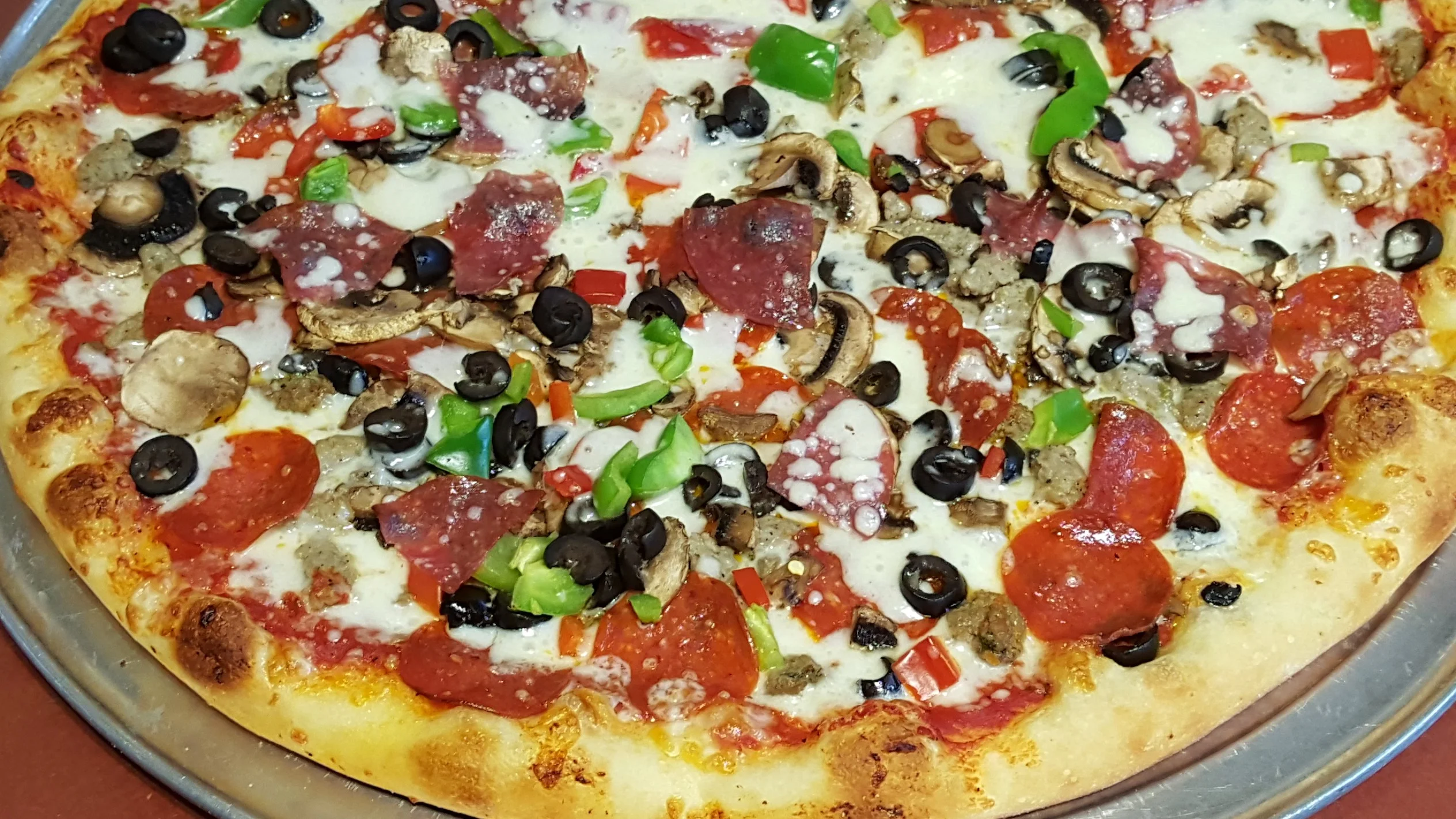 Loaded pepperoni pizza with olives and vegetables