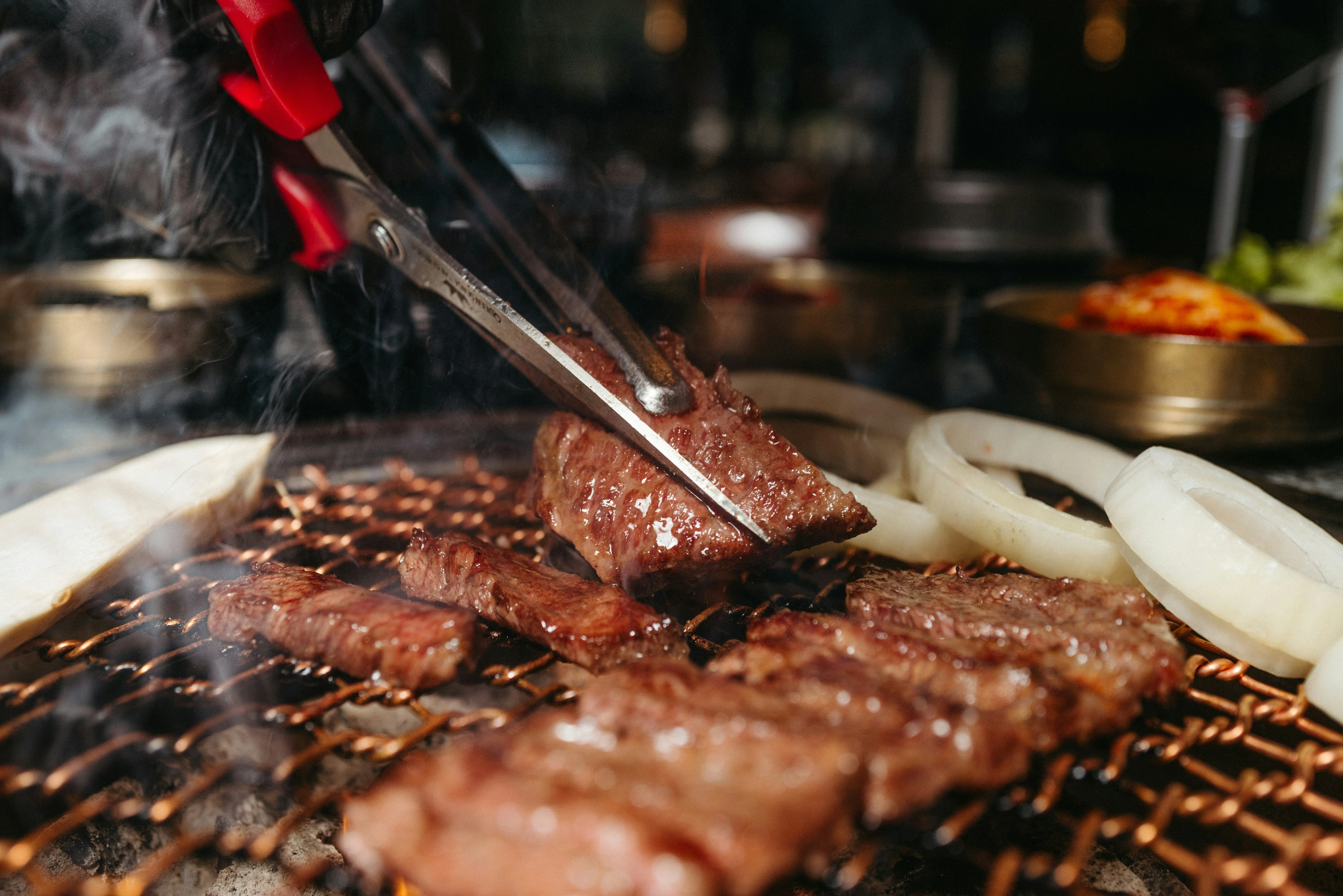 Grilling Korean bulgogi with onions on a barbecue
