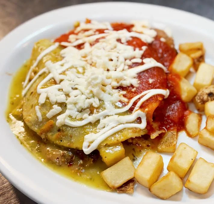 Delicious Mexican enchiladas topped with red sauce and cheese