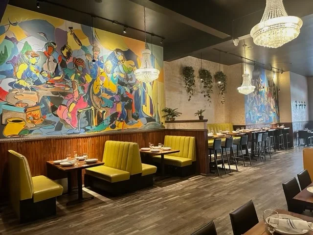 Colorful mural and booth seating inside Castro Indian Restaurant
