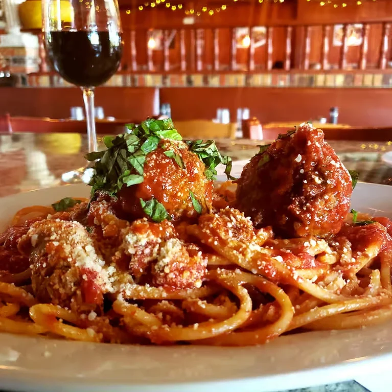 Oven-baked Italian dish topped with melted cheese and tomato sauce.