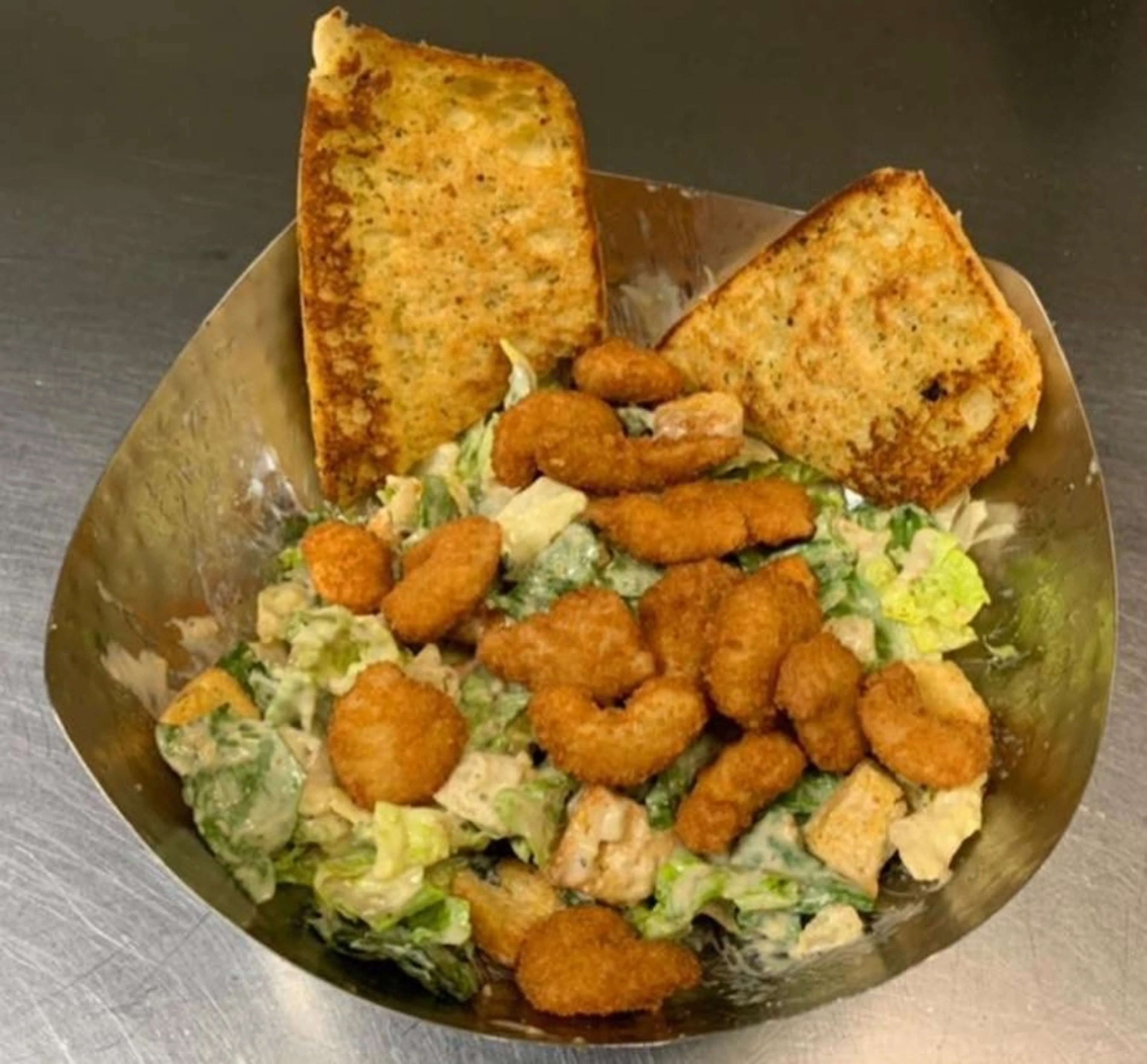 A popcorn shrimp salad with toast 