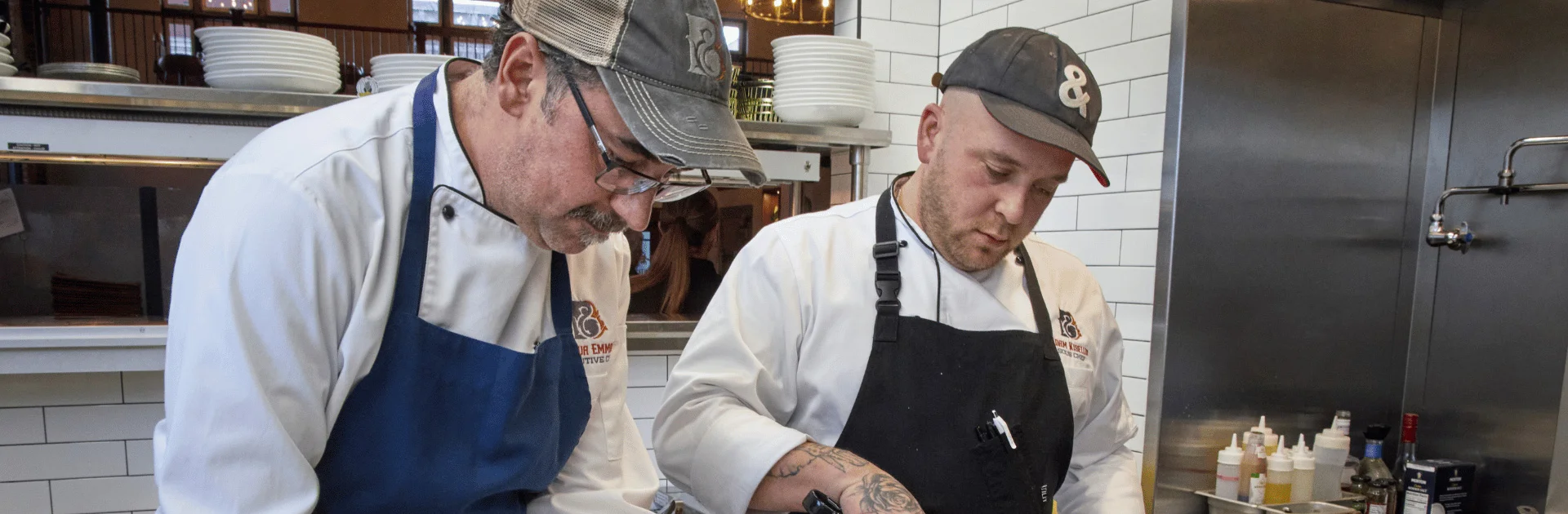 Chefs plating gourmet dishes in a modern kitchen