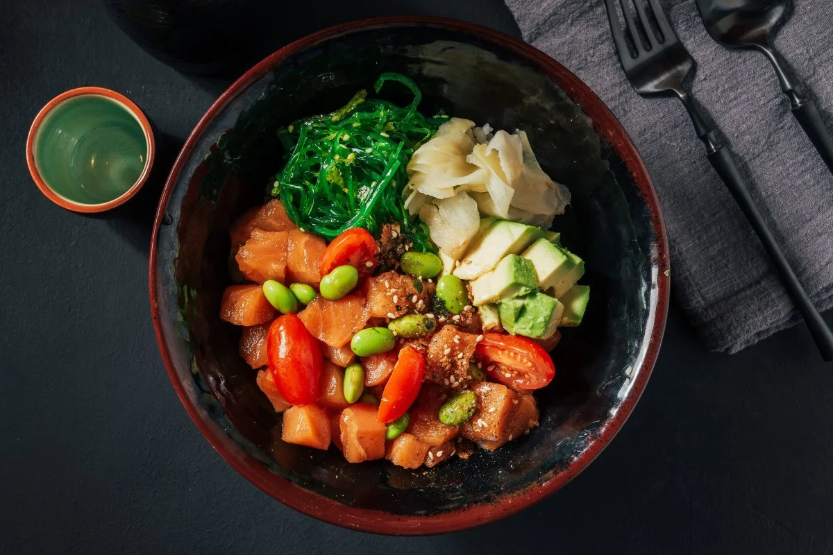 A vibrant salmon poke bowl with fresh ingredients and colorful toppings.