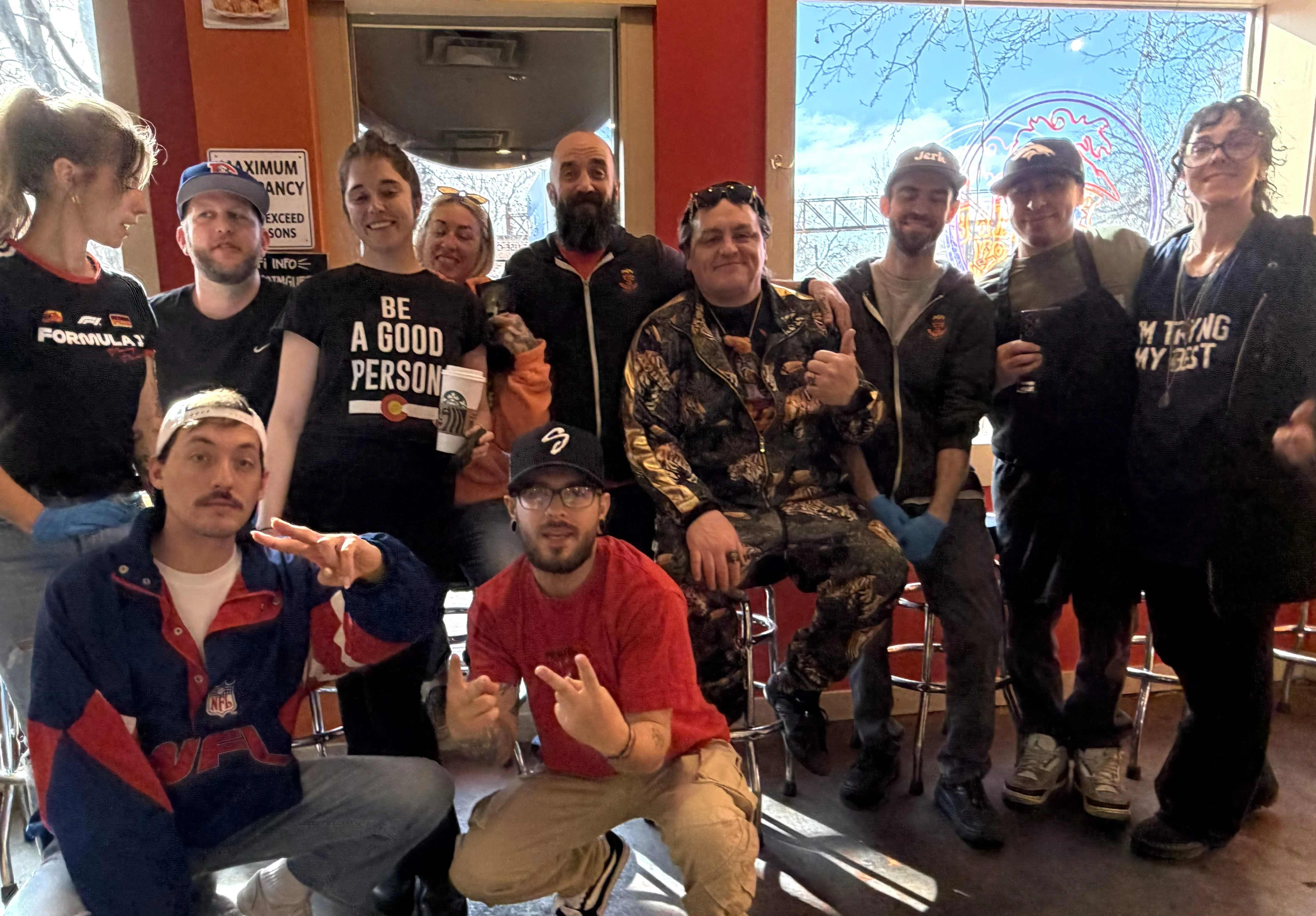 Friendly restaurant staff posing together in a vibrant dining space
