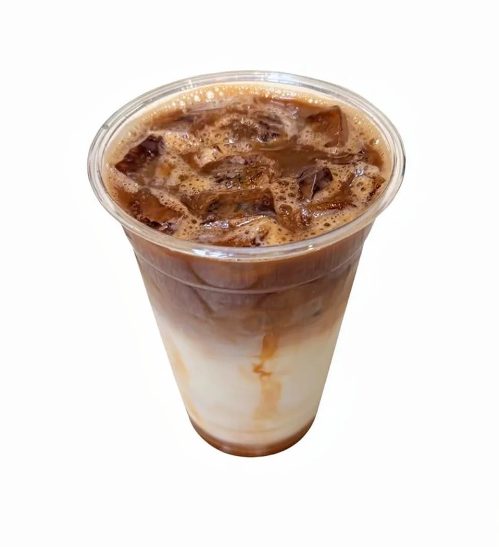 Iced coffee drink with layers of milk and chocolate in a clear cup