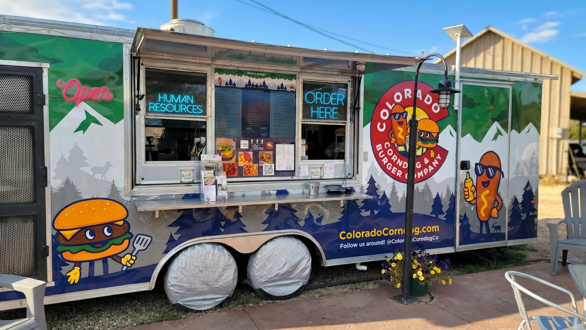 Colorful food truck serving burgers and corn dogs