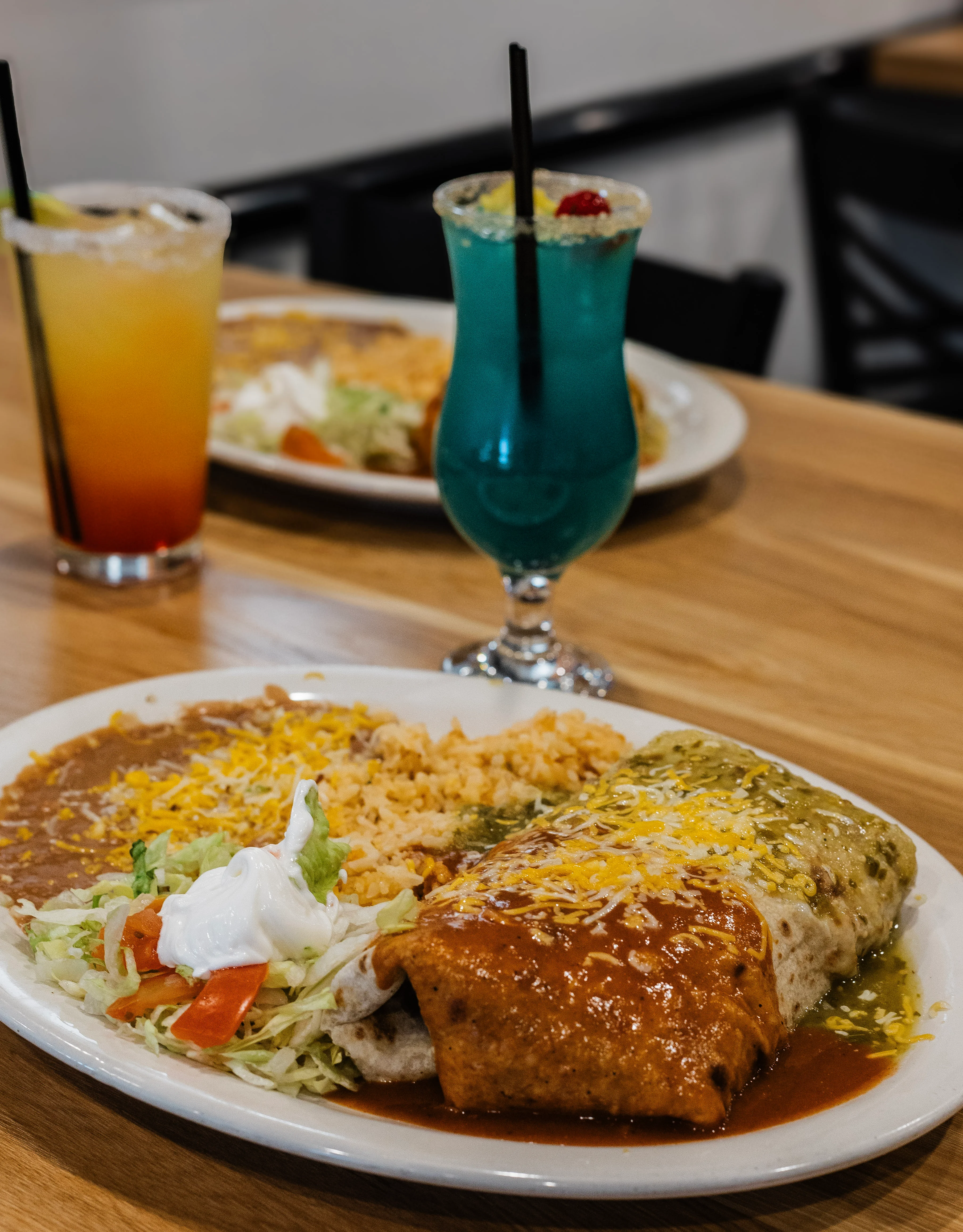 Plate of Mexican enchiladas with rice and beans