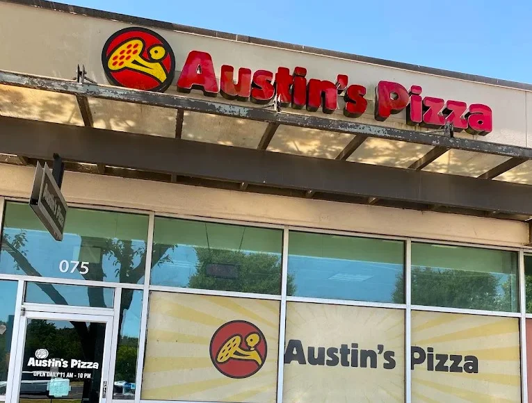Exterior view of Austin's Pizza restaurant with logo and signage
