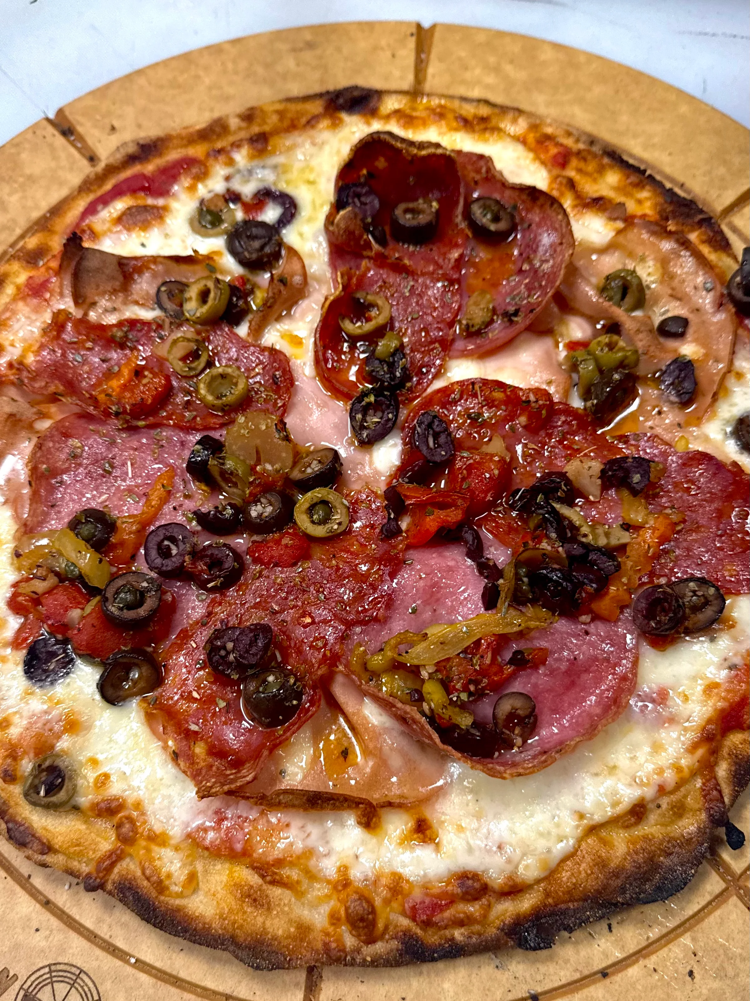 Italian pepperoni pizza with olives and herbs