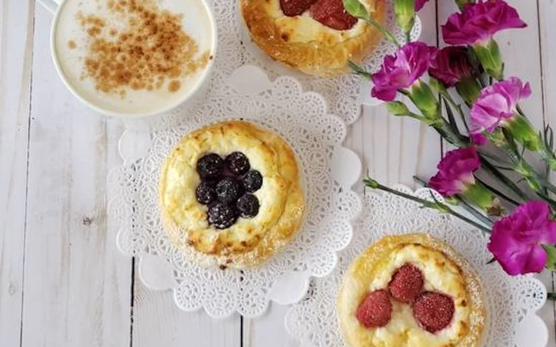 Delicious Danish pastries with coffee and flowers
