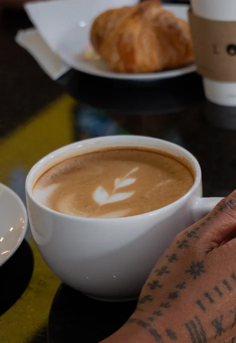 A to go cup of coffee with Lotus logo