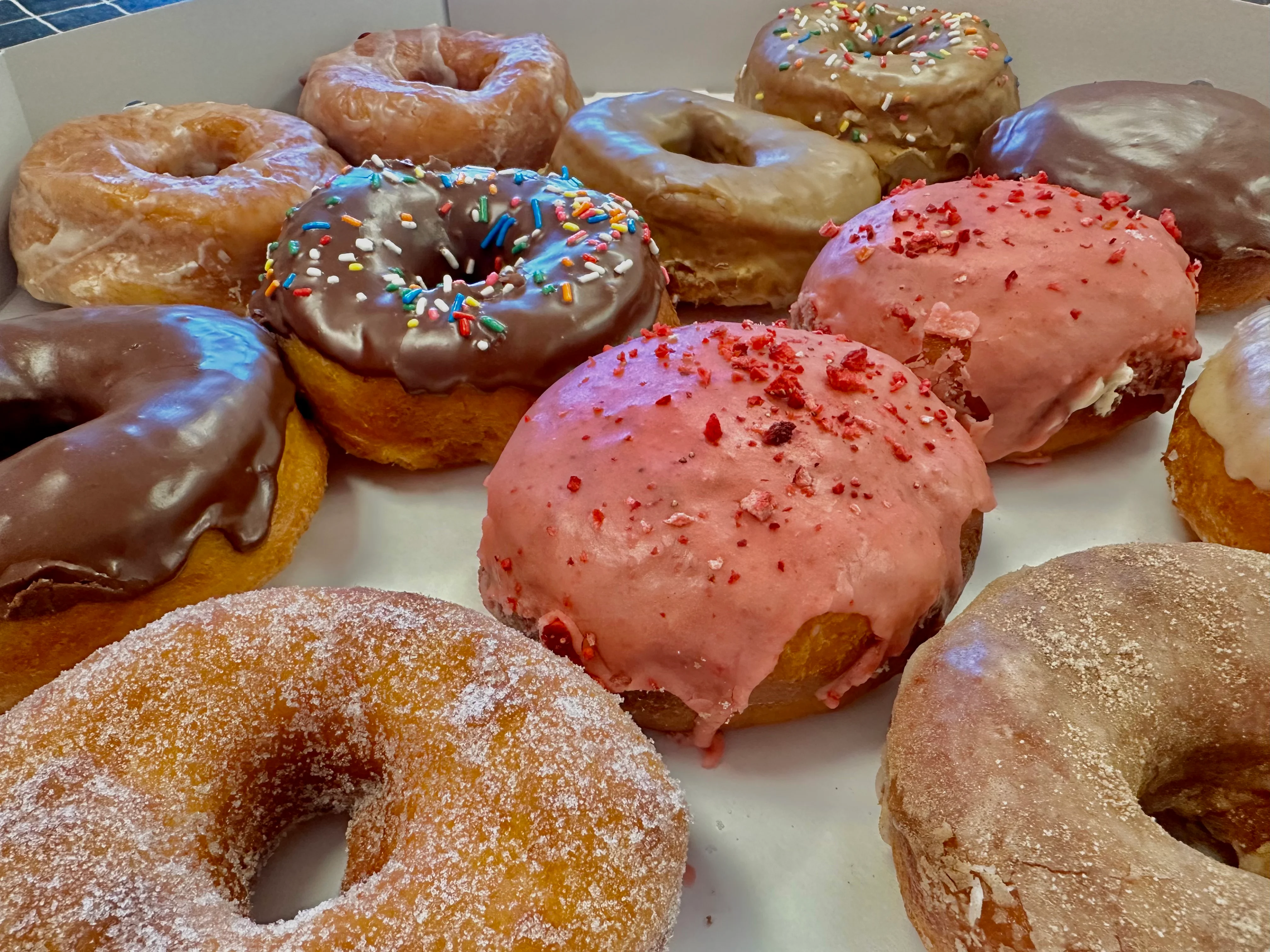Assorted donuts including chocolate and strawberry varieties