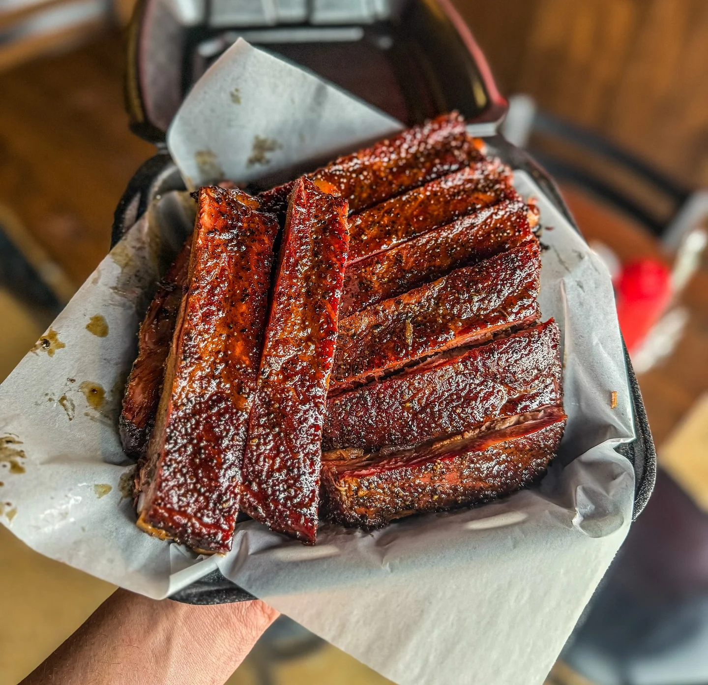 Smoked barbecue ribs served in a takeout container