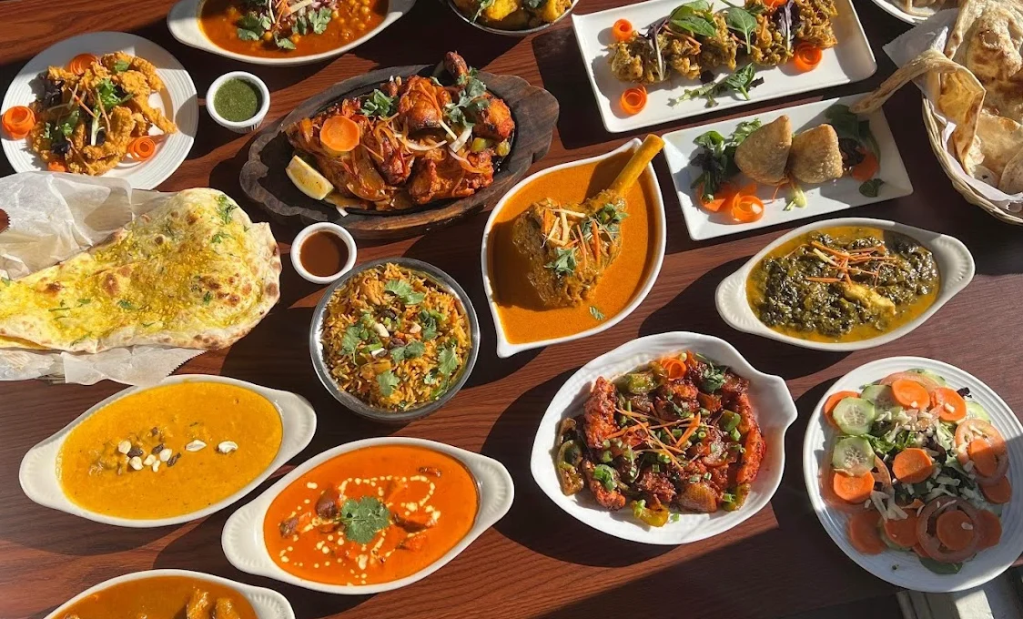 Assorted Indian dishes including curry, naan, and biryani