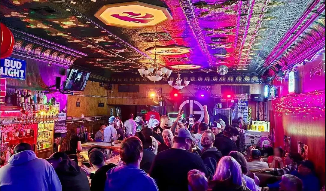 Vibrant bar scene with lively crowd and colorful lighting