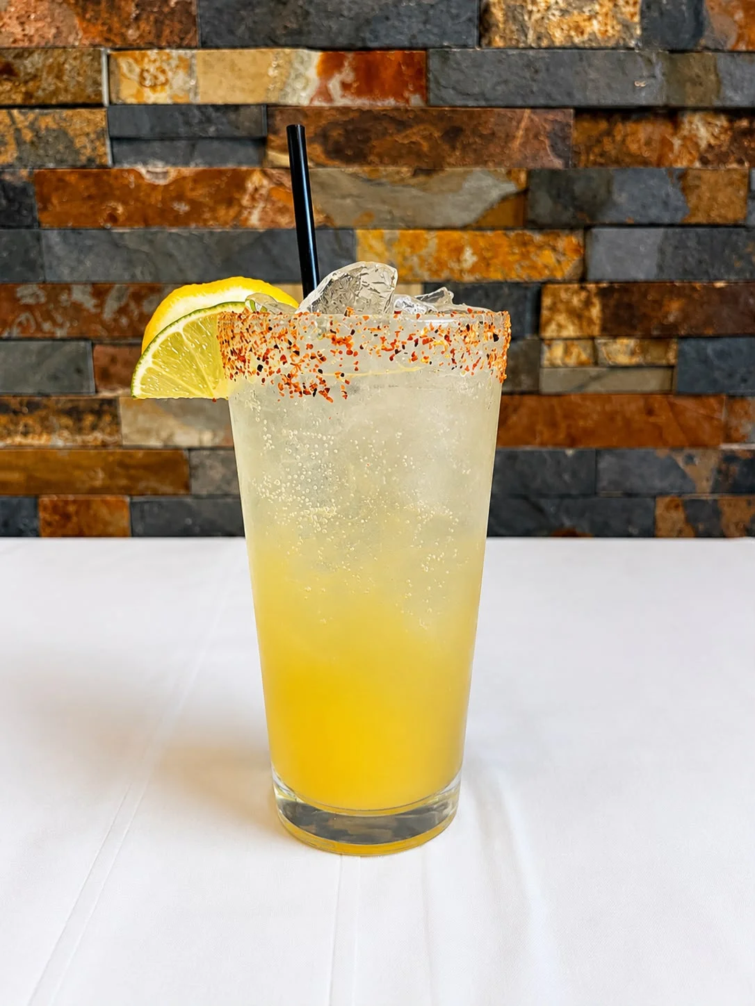 Refreshing Mexican cocktail with citrus and chili rim