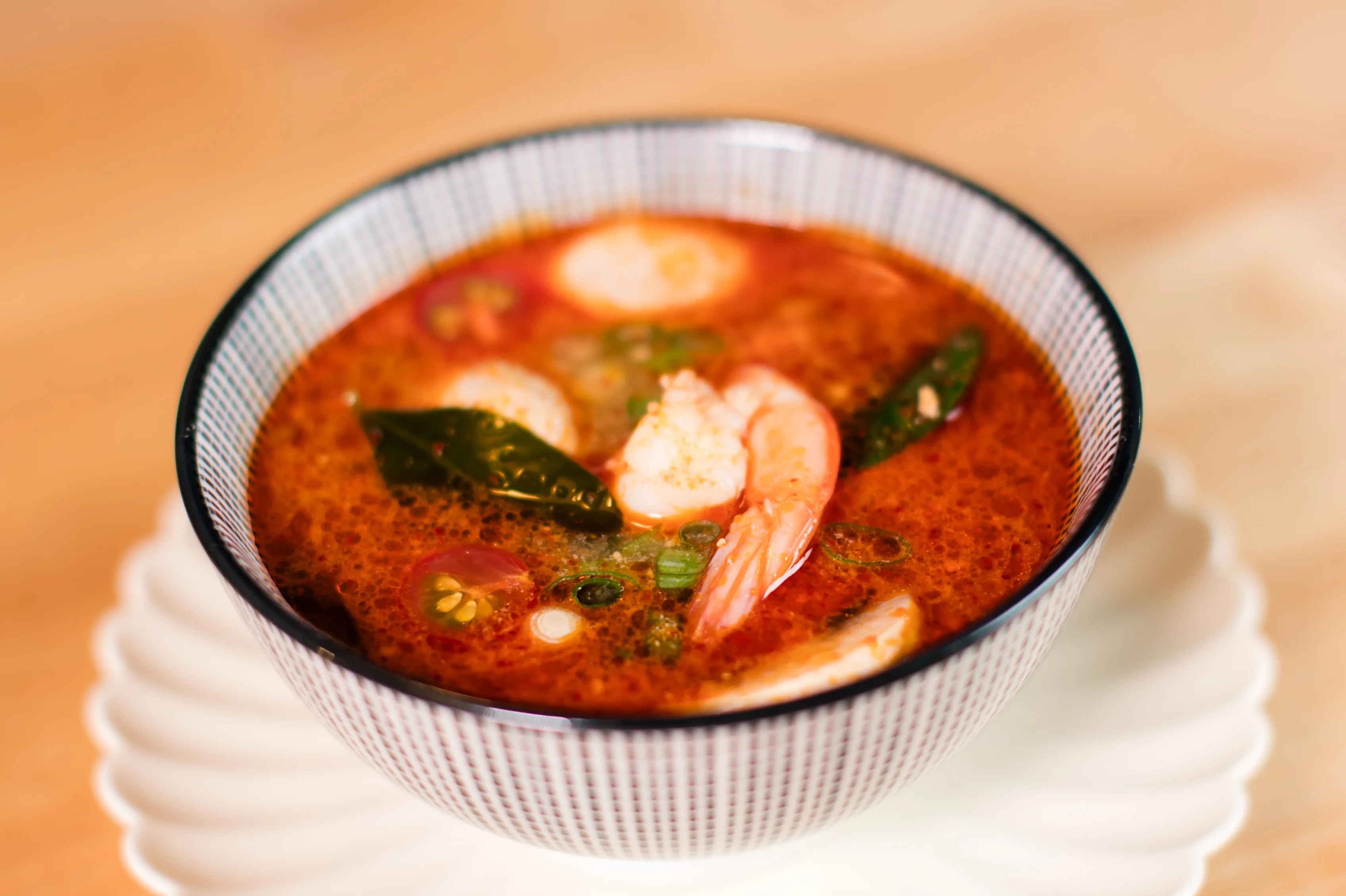 Spicy Thai tom yum soup with shrimp and herbs