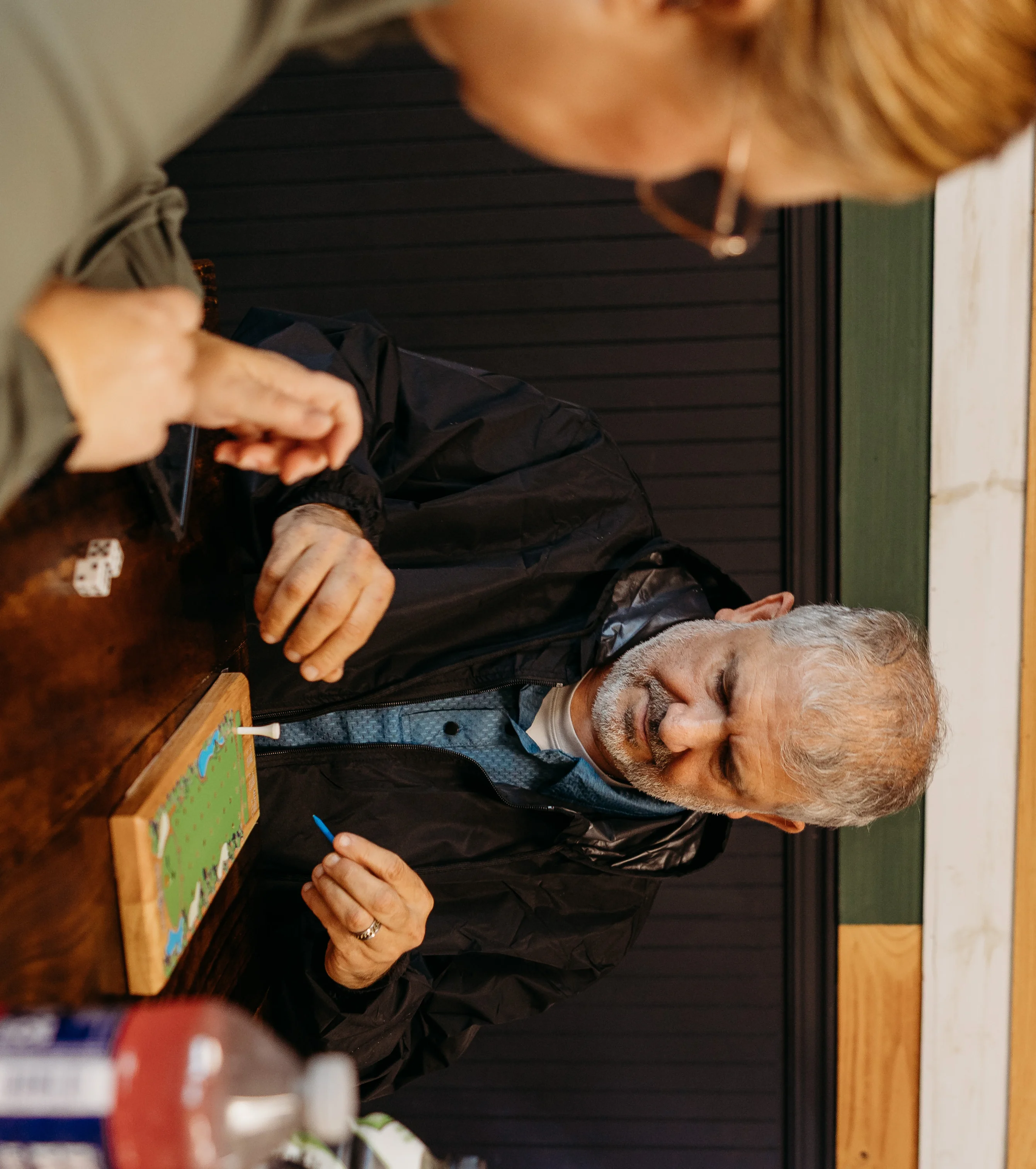 Casual dining scene with people playing a board game