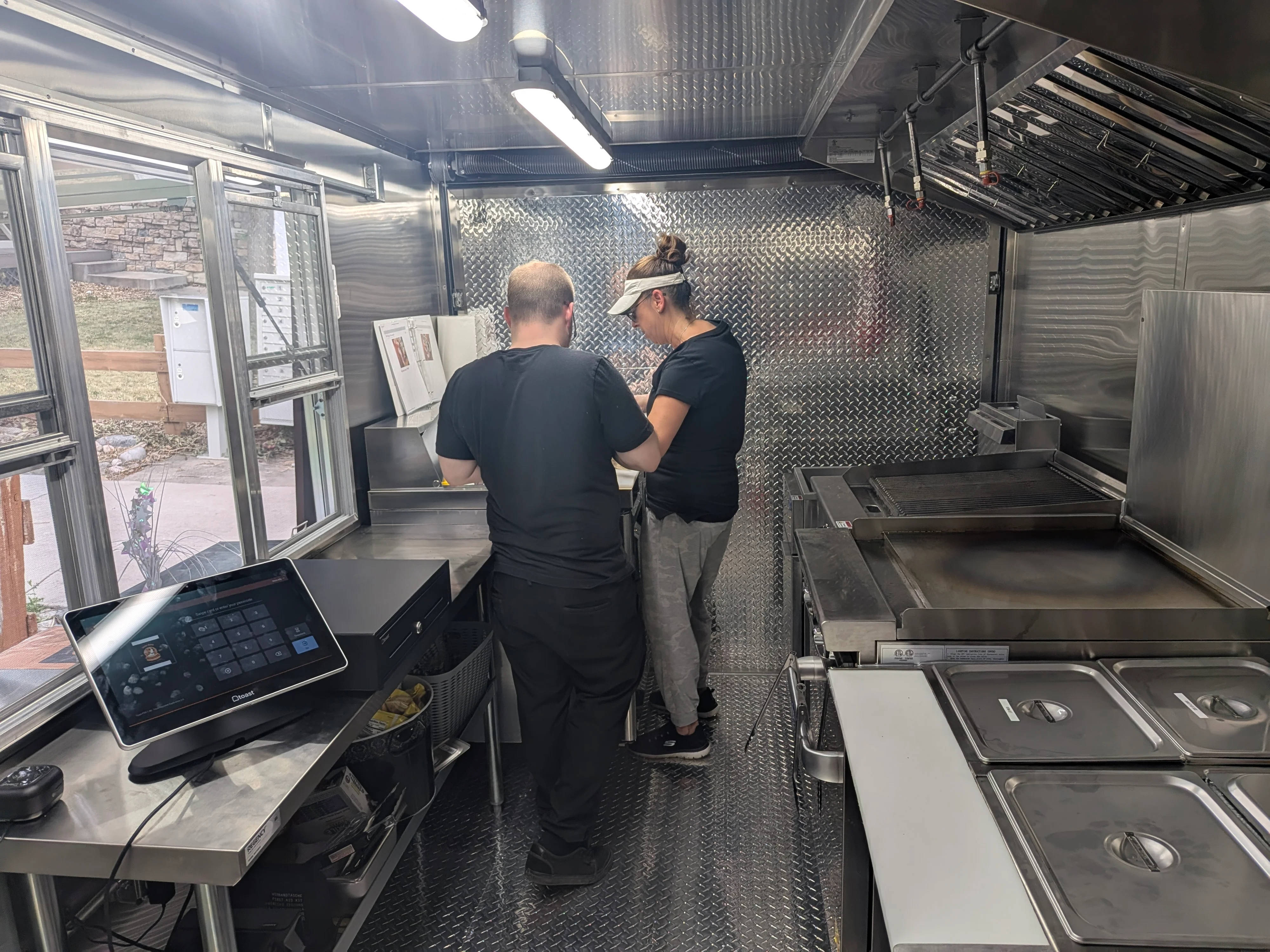Food truck kitchen with chefs preparing meals