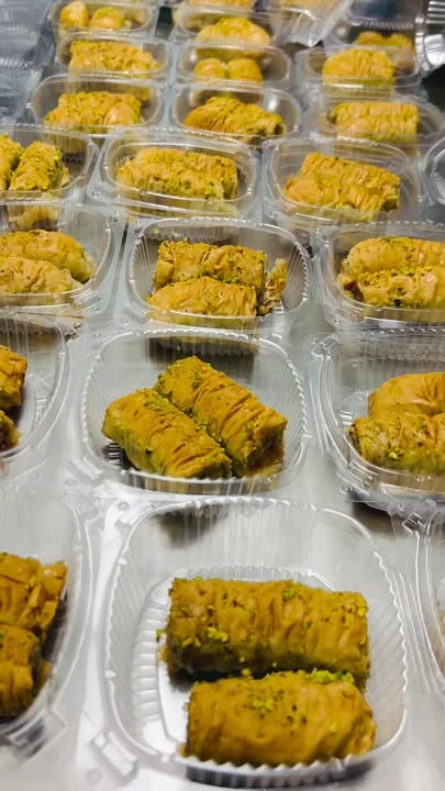 Delicious Mediterranean baklava with pistachios in clear containers