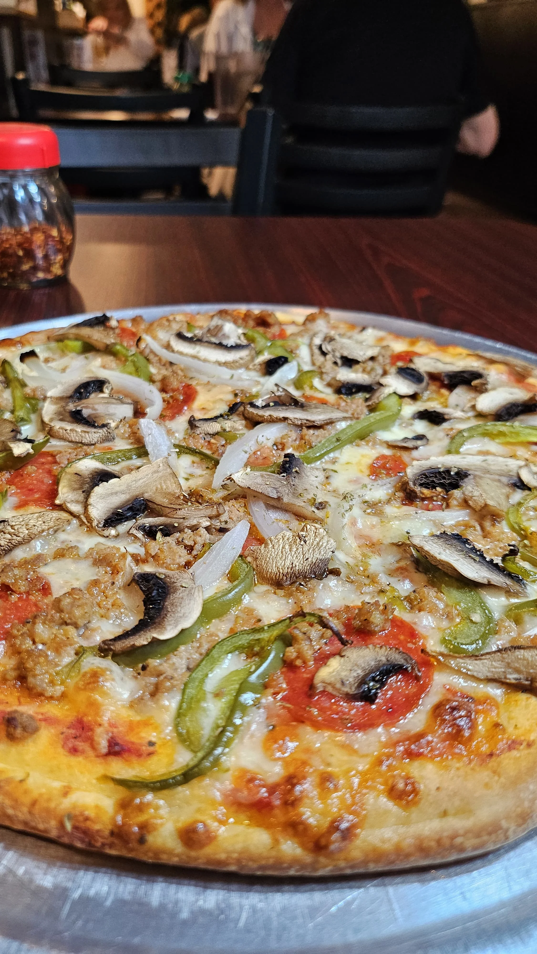 Delicious Italian sausage pizza with mushrooms and green peppers