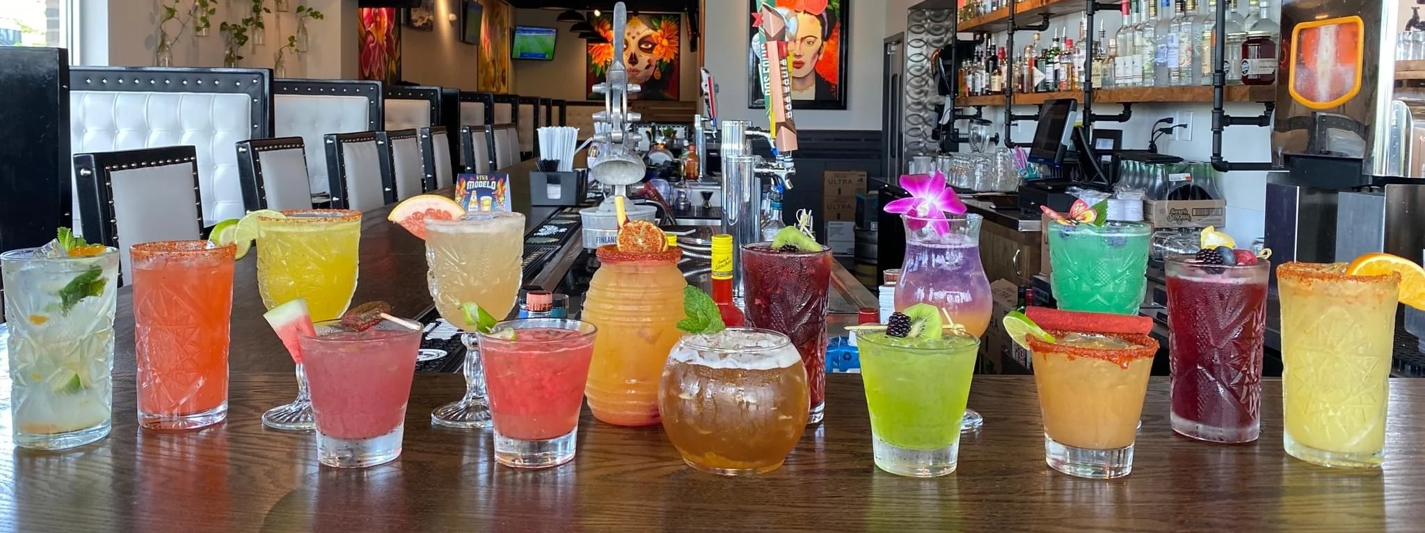 Colorful array of cocktails at a vibrant bar