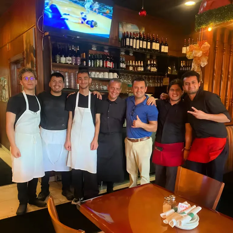 Fratelli's staff posing together inside the restaurant dining area.