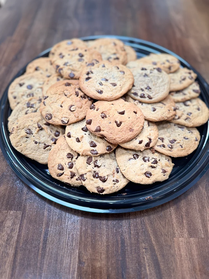 A tray of fresh baked chocolate chip cookies.