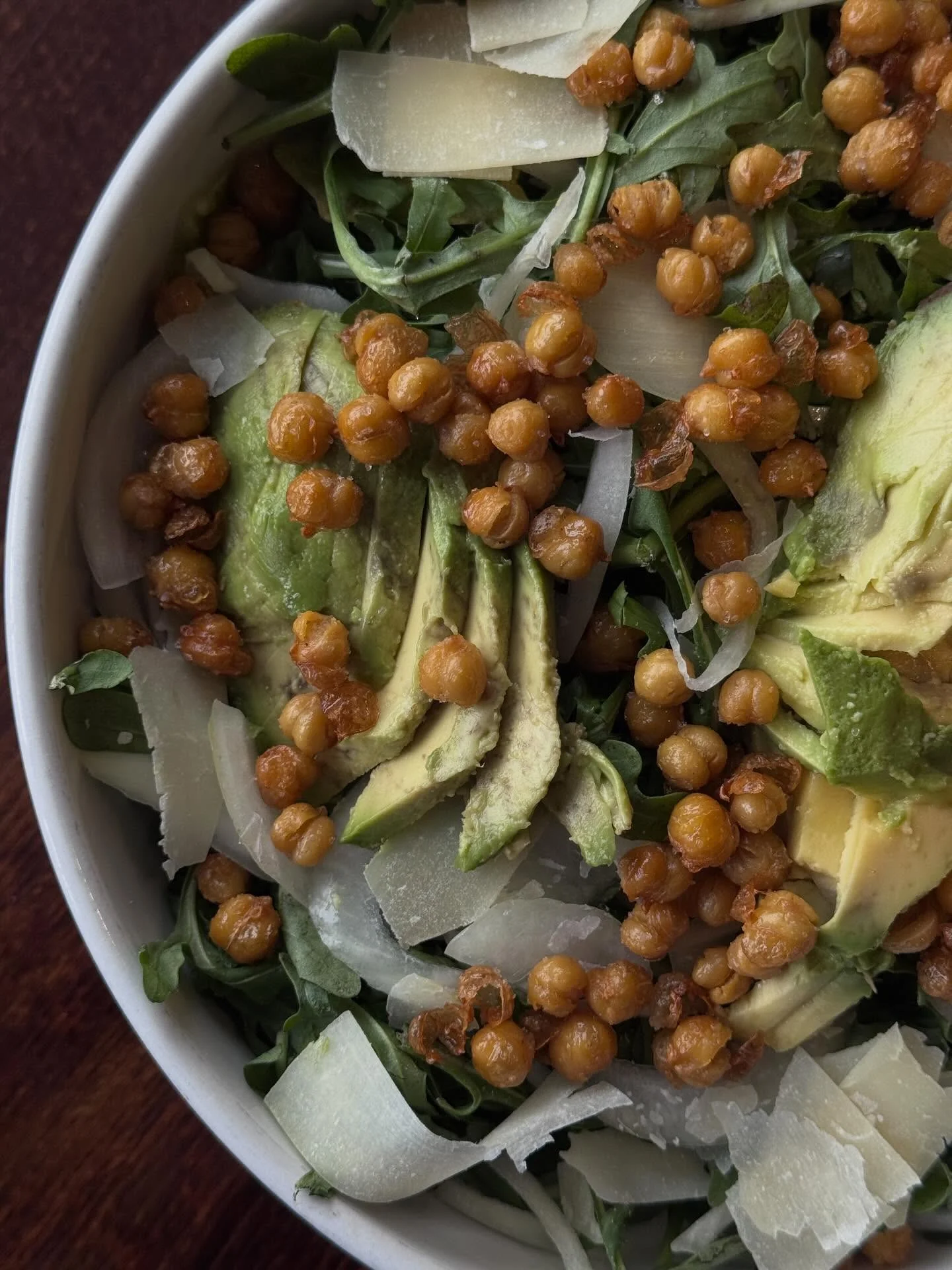 Fresh arugula salad with avocado and crispy chickpeas