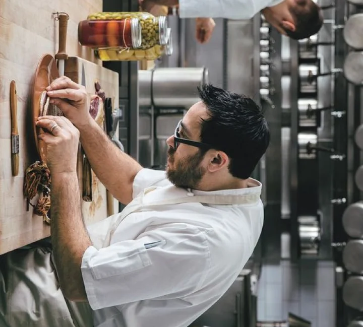 A restaurant chef preparing a dish