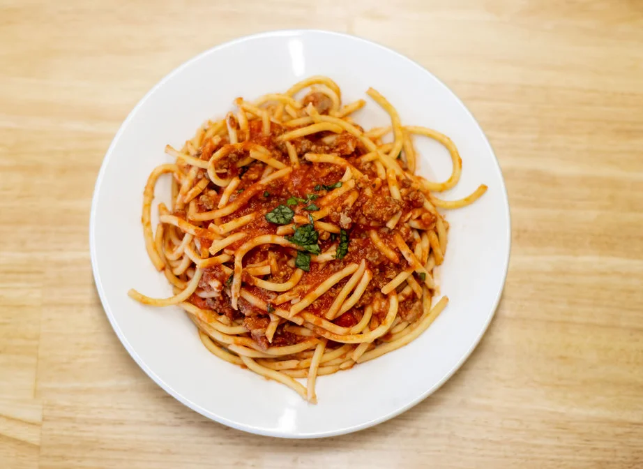 Classic spaghetti bolognese served in a white bowl