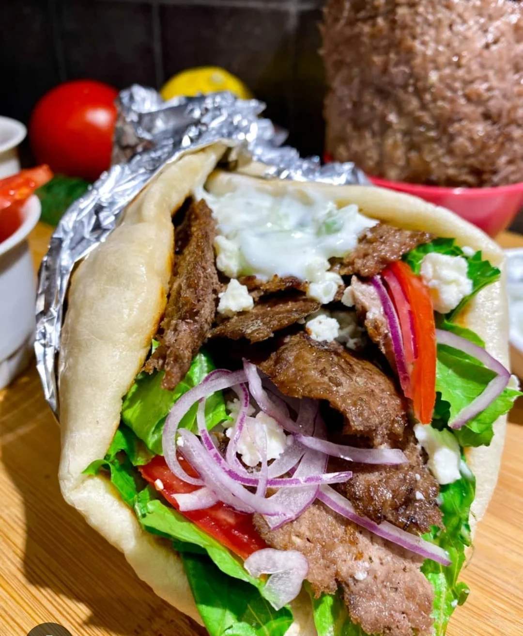 Delicious Greek gyro wrapped in pita with fresh vegetables