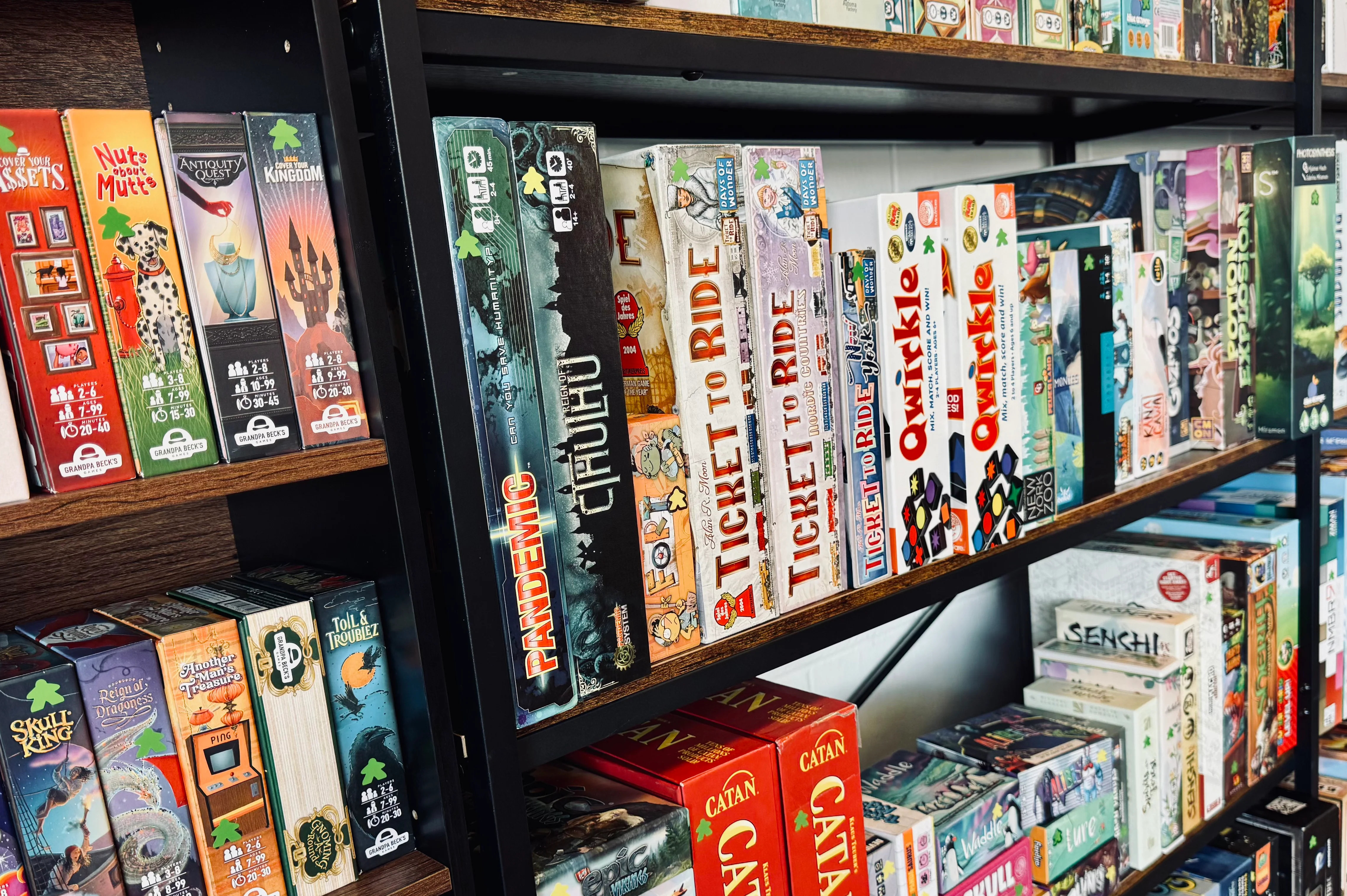 Colorful board game collection on shelves
