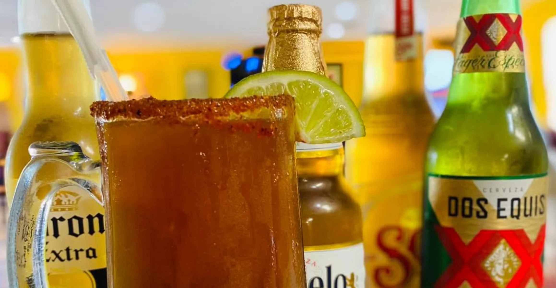 Refreshing Mexican michelada with lime and beer bottles
