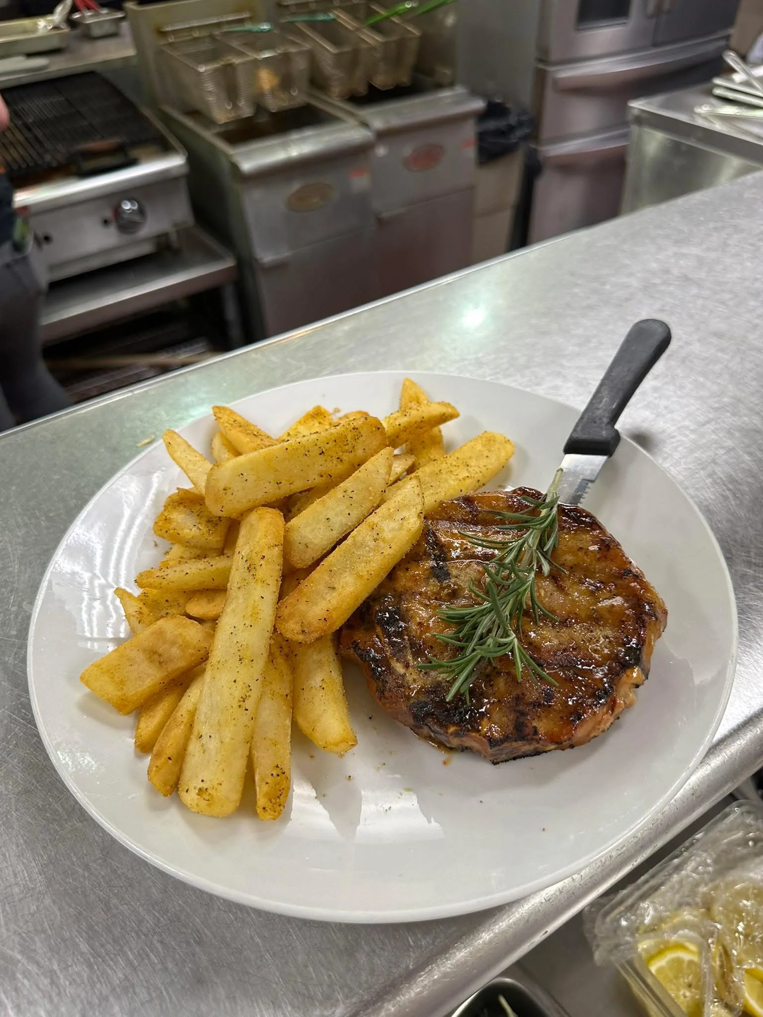 Grilled pork chop with seasoned fries