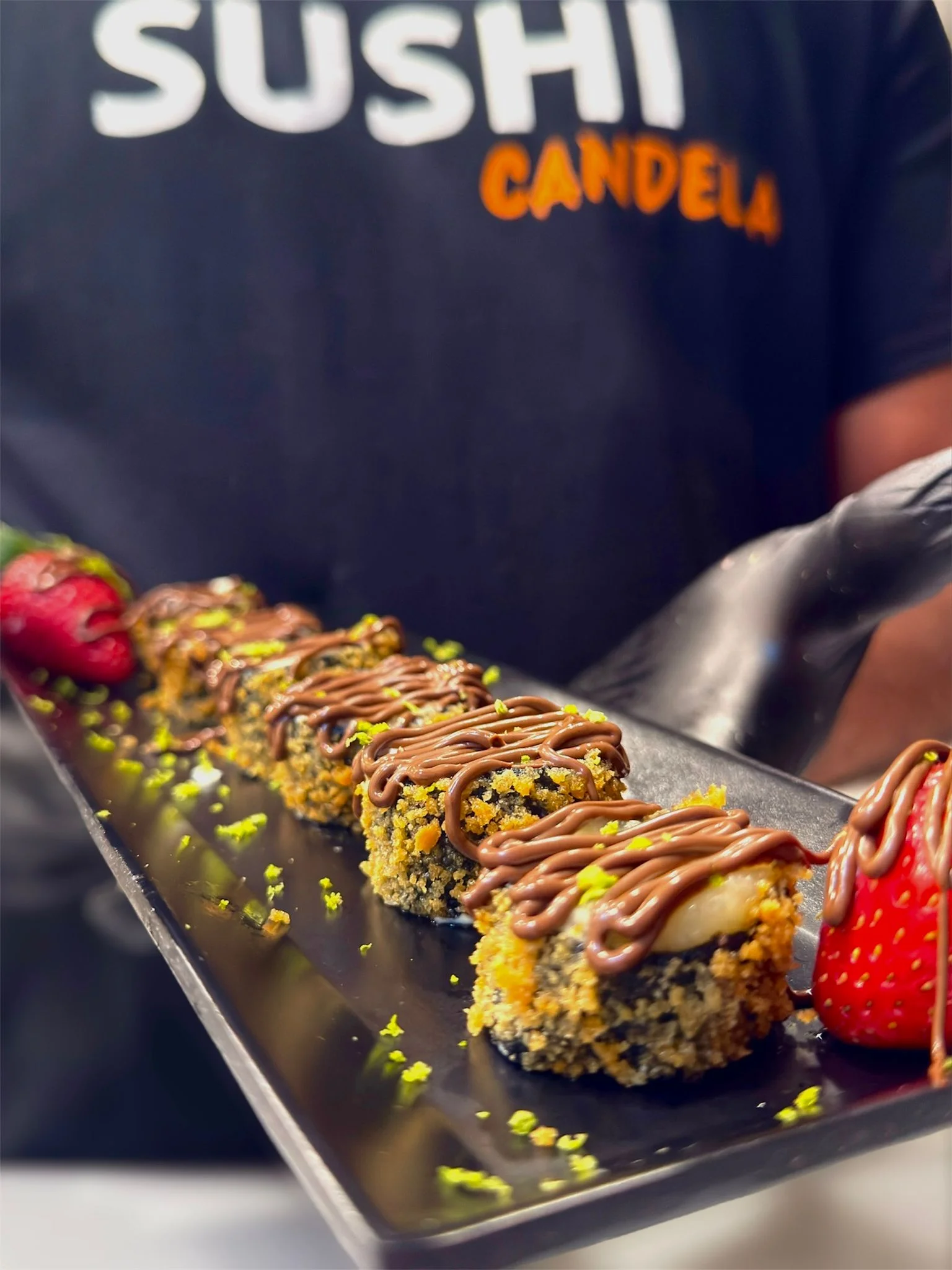 Japanese sushi roll with chocolate drizzle and strawberries