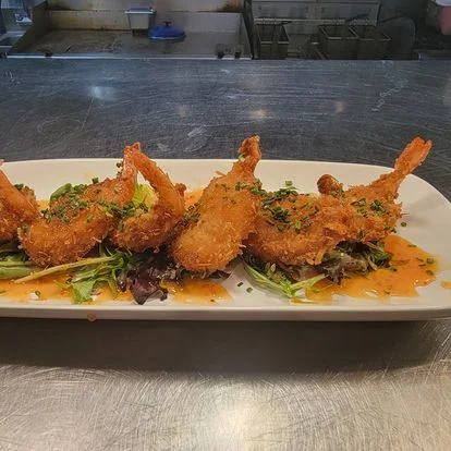 Crispy coconut shrimp with salad and sauce