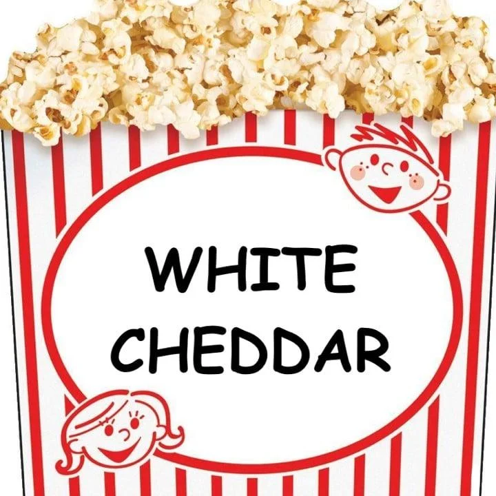 A popcorn container labeled 'WHITE CHEDDAR' with a design featuring cartoon characters, surrounded by white popcorn.