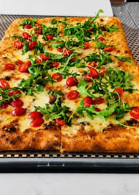 Fresh arugula and cherry tomato pizza