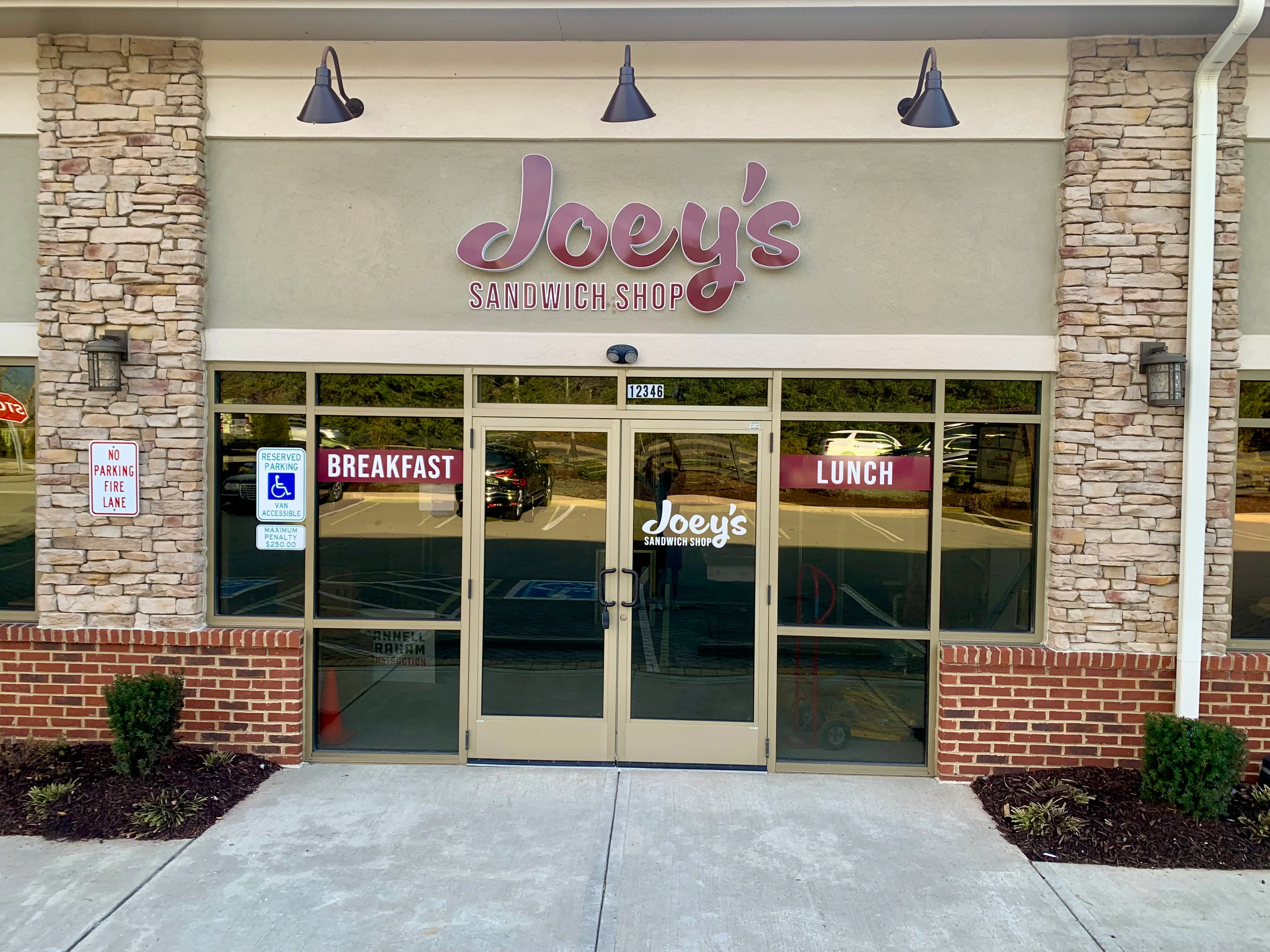 Exterior view of Joey's Sandwich Shop with breakfast and lunch signs