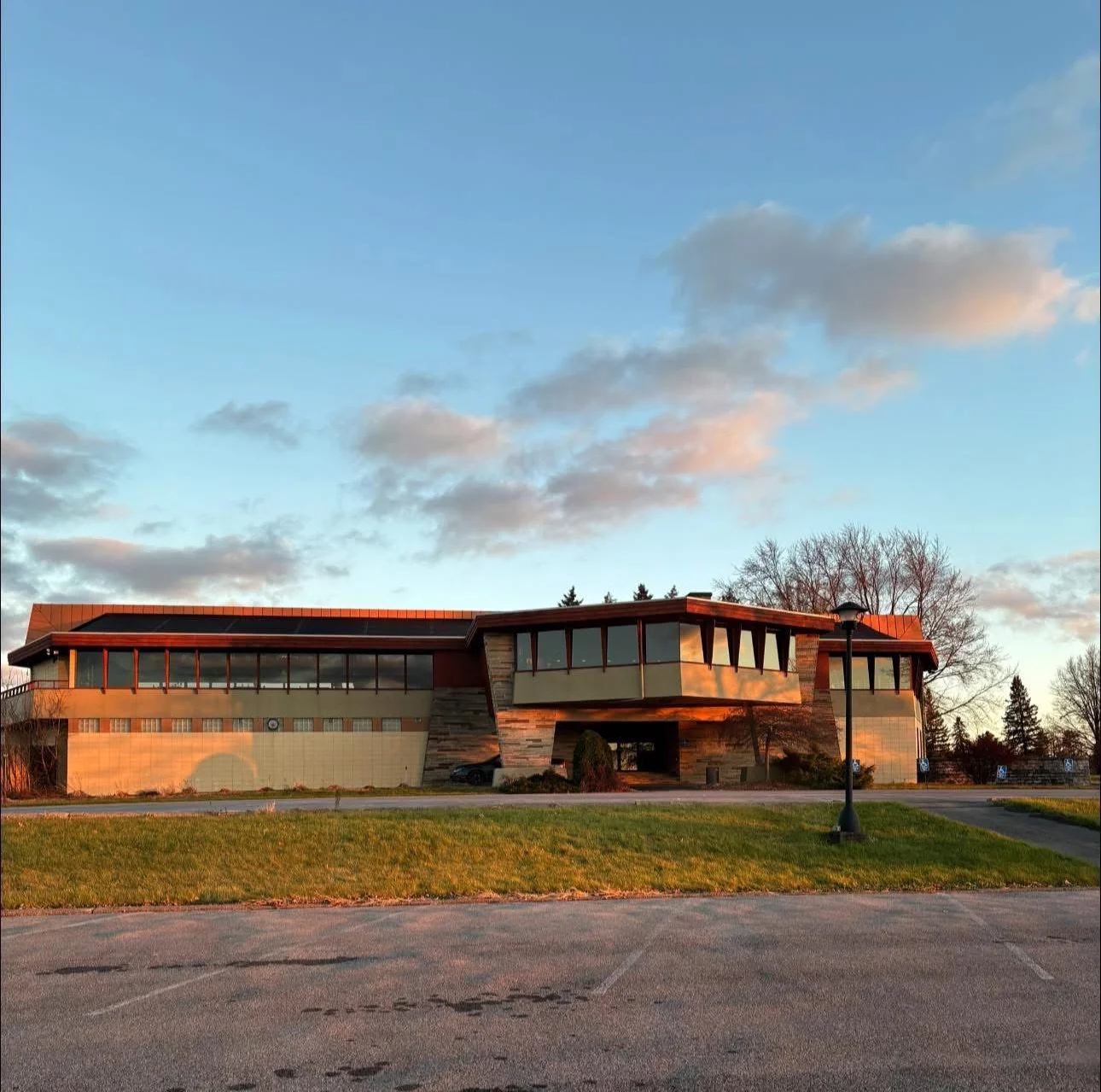 Modern restaurant building with large windows and scenic surroundings