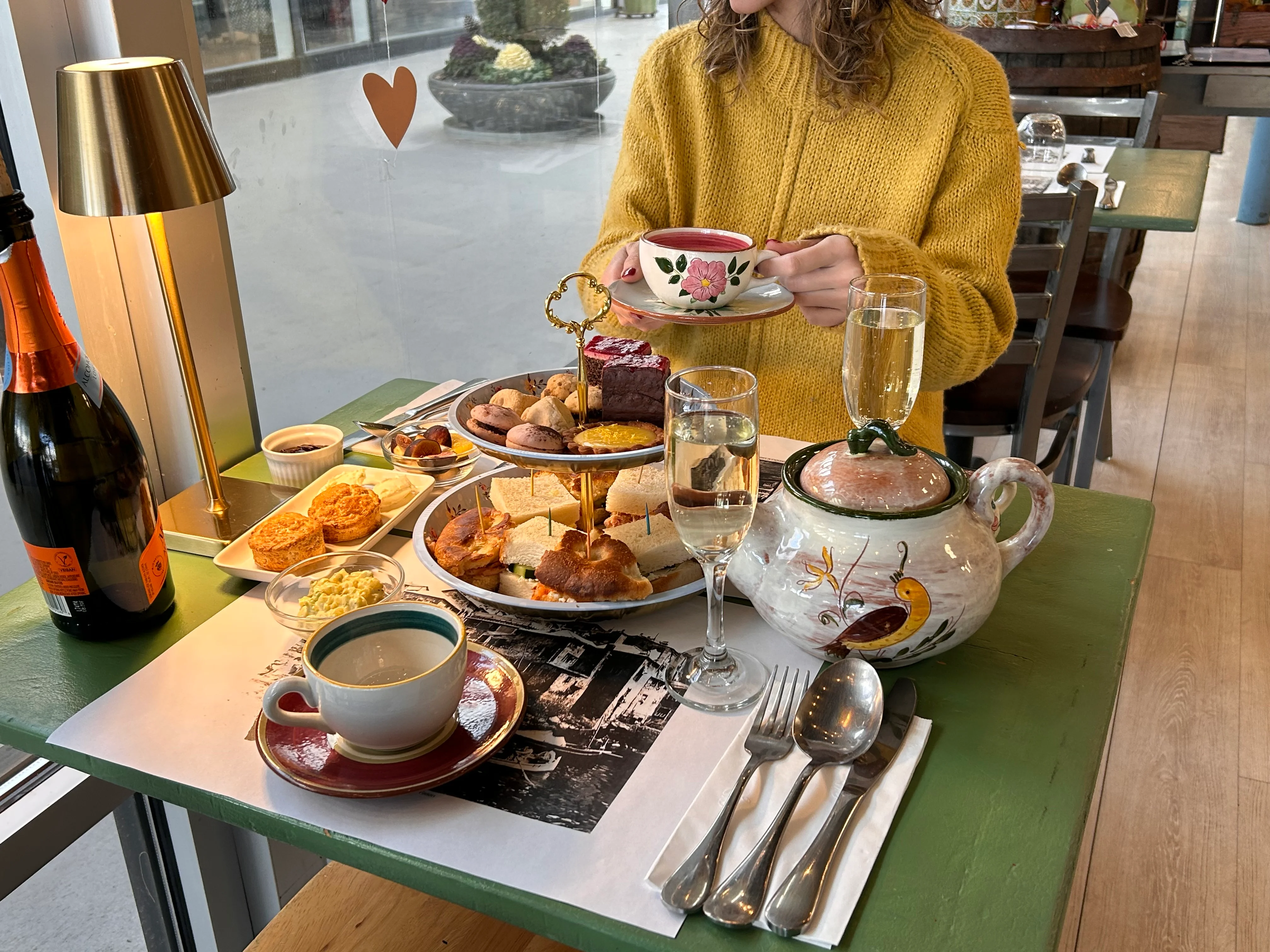 Elegant afternoon tea set with pastries and champagne