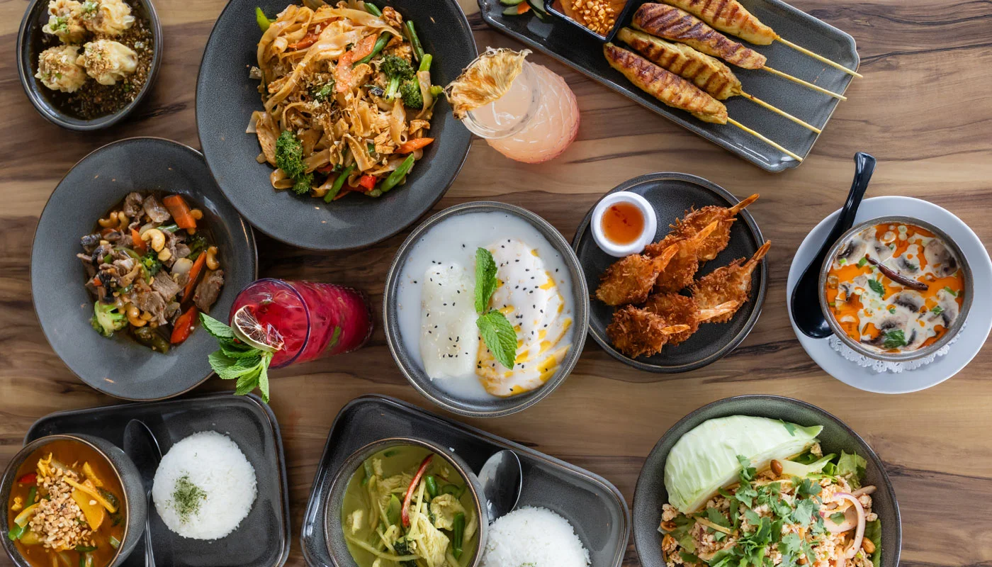 Assorted Thai dishes including pad thai and tom yum soup