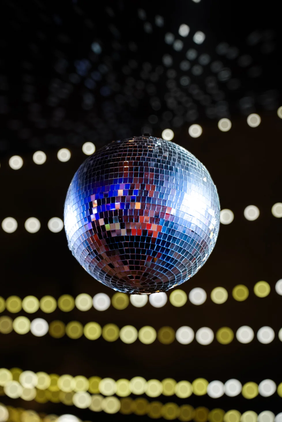 Shimmering disco ball reflecting colorful lights