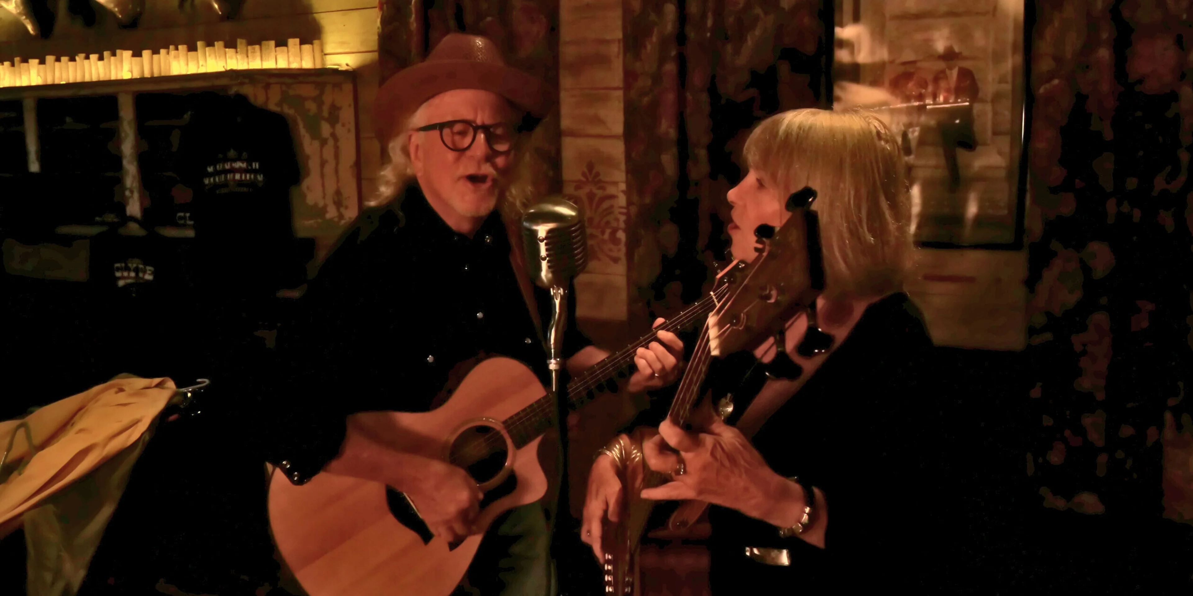 Live music performance with acoustic guitars in a cozy venue